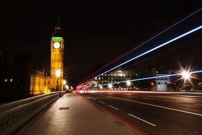 Light trails on illuminated building at night