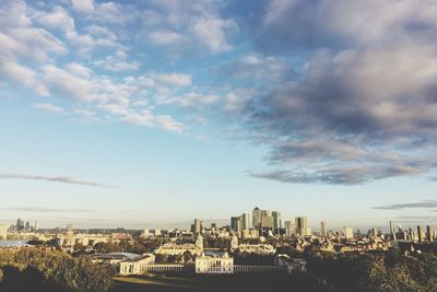 Cityscape against cloudy sky