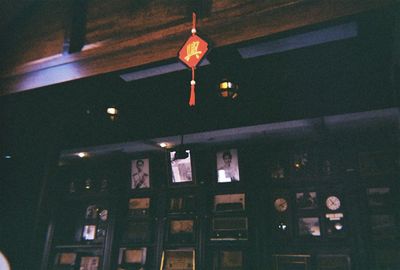 Low angle view of illuminated pendant lights hanging on ceiling