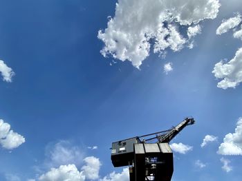 Low angle view of communications tower against blue sky