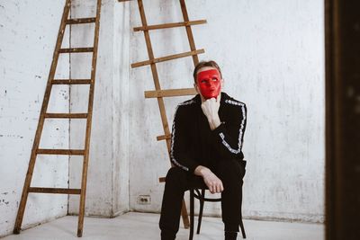 Portrait of man sitting on chair