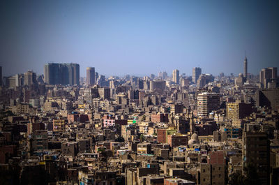 Modern buildings in city against clear sky