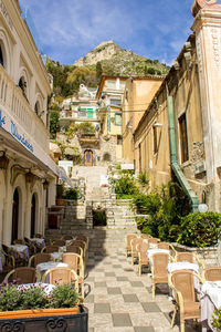 Alley amidst buildings in city against sky