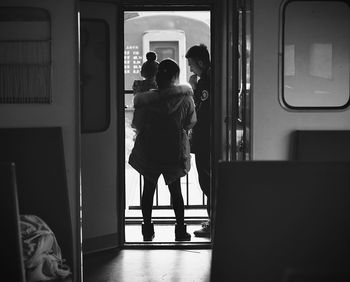 Rear view of people traveling in train