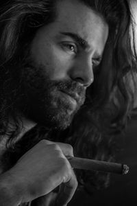 Portrait of young man smoking cigarette