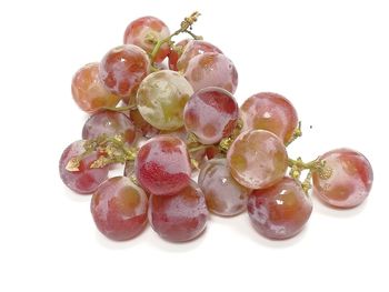 Close-up of grapes over white background