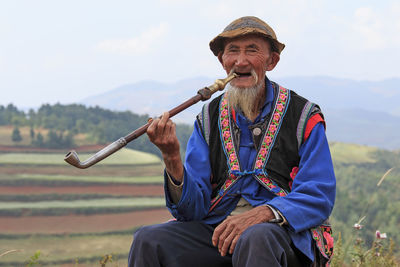 Low angle view of man holding umbrella on field