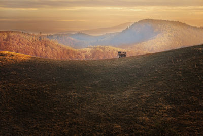 Scenic view of field against sky during sunset