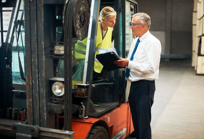 Manager talking to employee at warehouse