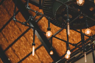 Low angle view of illuminated chandelier hanging from ceiling