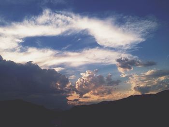 Scenic view of mountains against cloudy sky