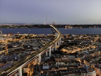 High angle view of illuminated buildings by city against sky