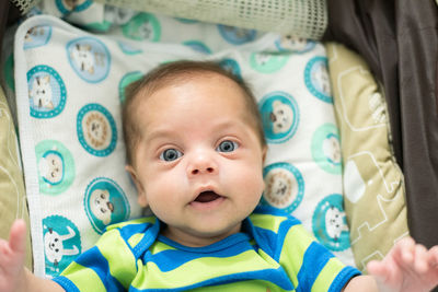 Portrait of cute baby lying on carpet