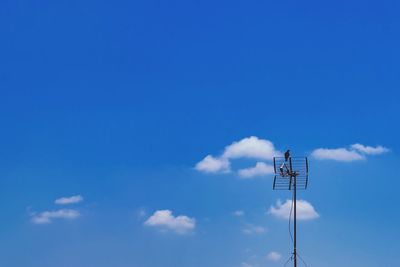 Low angle view of floodlight against blue sky