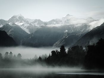 Scenic view of lake and mountains against sky