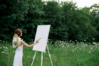 Side view of woman standing on field