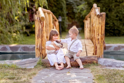 Boys and woman standing on wood