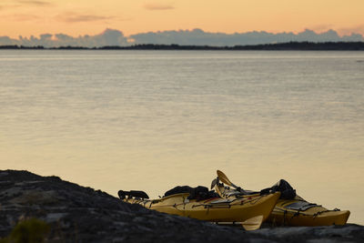 Kayaks on rocks at sea