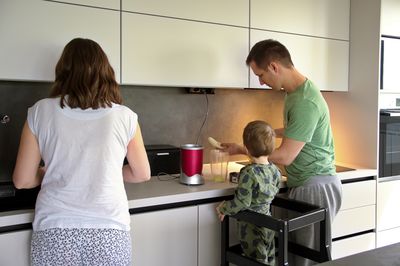 Side view of woman preparing food at home