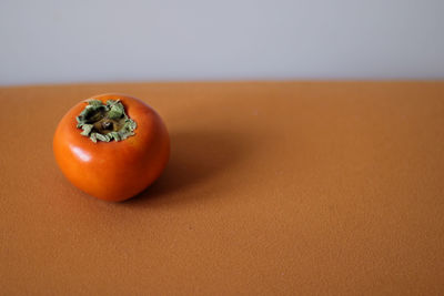 Close-up of persimmon on table