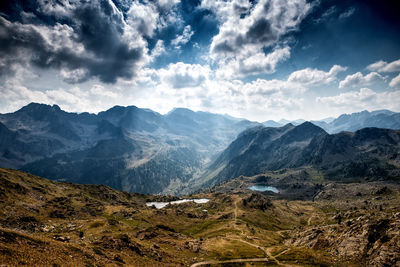 Scenic view of mountains against cloudy sky