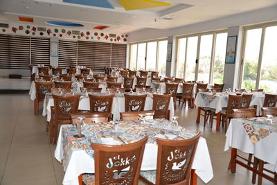 Empty chairs and tables in restaurant