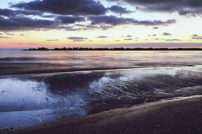Scenic view of sea against cloudy sky