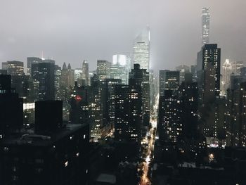 Aerial view of illuminated buildings in city at night