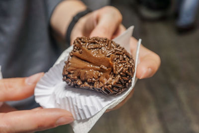 Close-up of hand holding ice cream