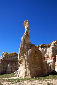 Rock formation against clear blue sky