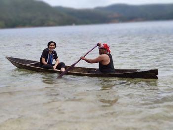 People in boat on sea