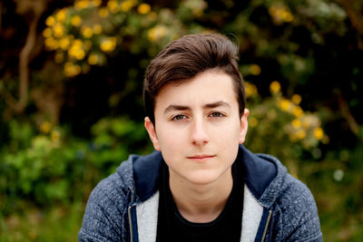 Portrait of boy sitting outdoors