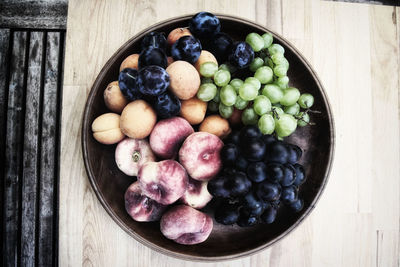 High angle view of grapes in bowl on table