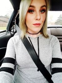 Portrait of beautiful woman in car