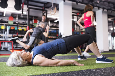 Fit senior woman exercising in gym