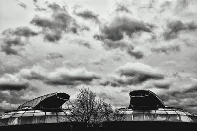 Low angle view of building against cloudy sky