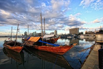 Boats moored at harbor