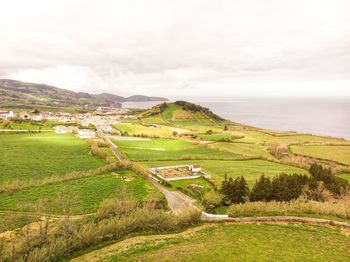 Scenic view of landscape and sea against sky