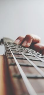 Close-up of hand playing guitar