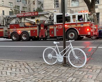 Bicycle parked on road in city