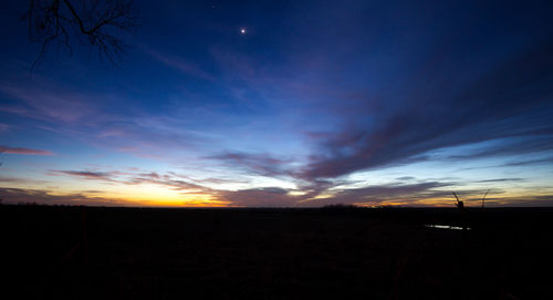 Scenic view of silhouette landscape against sky at sunset