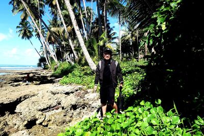 Portrait of man standing by tree