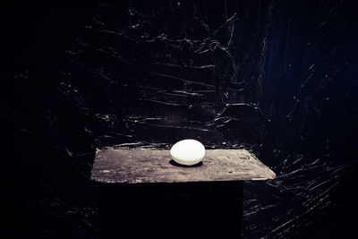 Close-up of ball on table against wall