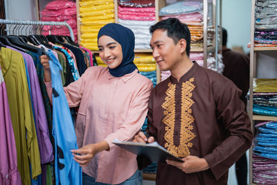 Portrait of young woman standing in store