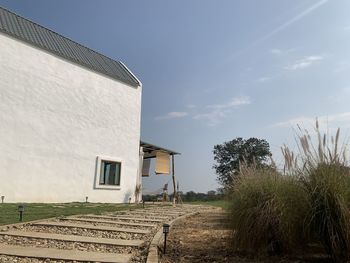 Houses on field against sky