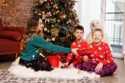 Merry christmas and happy holidays. cheerful cute baby siblings opening gifts.