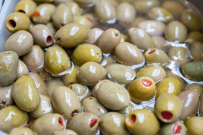 Green olives stuffed with paprika. food background