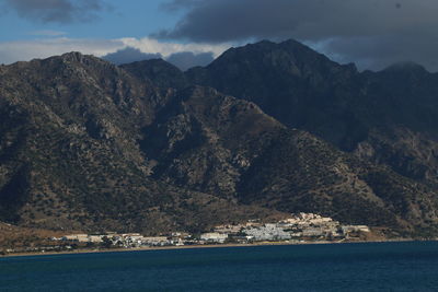 Scenic view of sea and mountains against sky