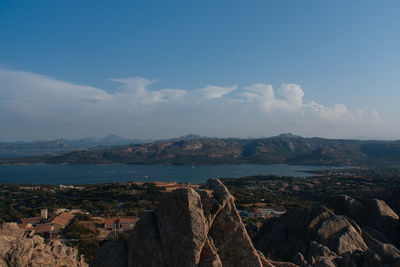 Aerial view of townscape by sea against sky