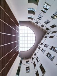 Low angle view of skylight shining through roof of building 